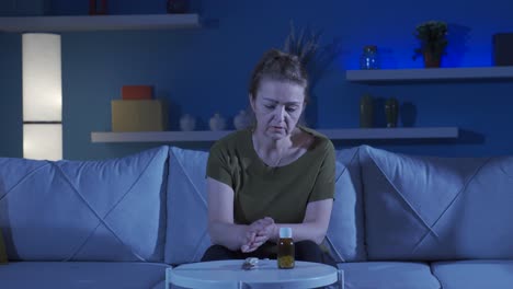 troubled woman looking at knife and pills in front of her.