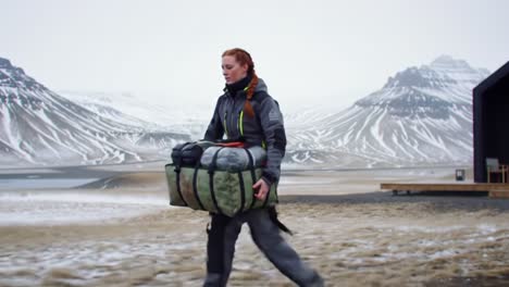 a determined adventurer traverses a rugged alpine landscape with a heavy pack, showcasing resilience and spirit in a breathtaking wilderness setting