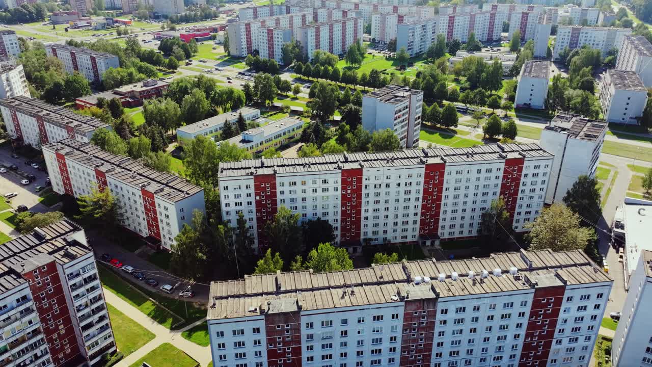 Massive apartment blocks form dense grid between greenery, Pļavnieki Riga Latvia