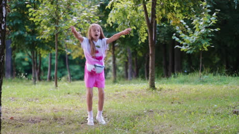 little girl outdoors. portrait of cheerful little girl in park