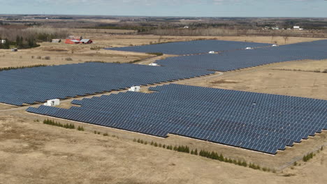 a solar farm with massive solar panels filmed from the air