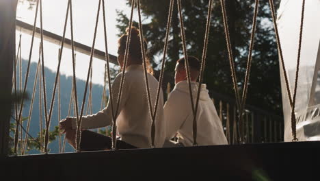 couple sitting together on a deck with a beautiful mountain view