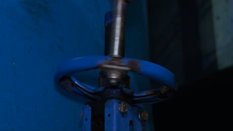 a worker is closing the valve in the water tank