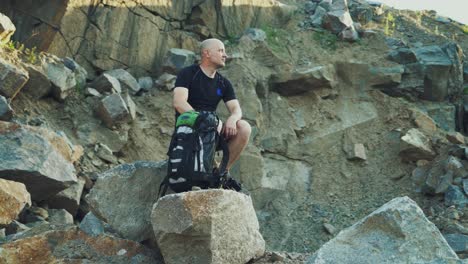 tourist resting after hike way. view of weary traveler taking break after active walk in mountains