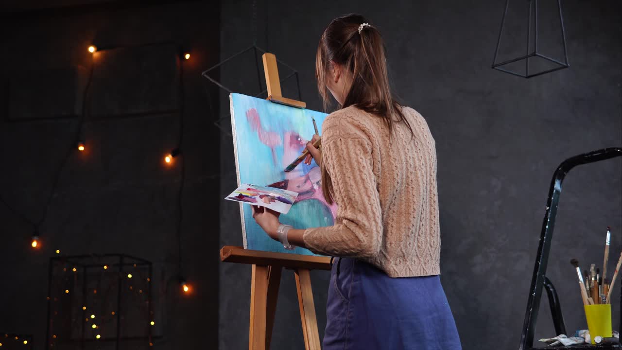 Woman painting a picture in a studio