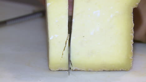 cutting a wedge of cheese