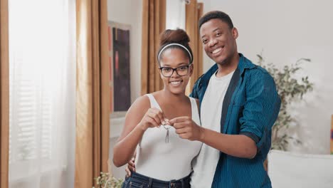 married couple buying, renting a new apartment, the beginning of their journey together, real estate industry, investment, hold the keys to the house in their hands
