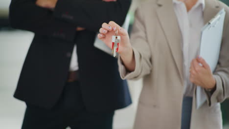 real estate agent holding keys to new dream house