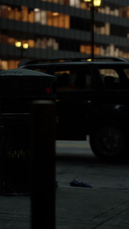 a trash can on a city street at night