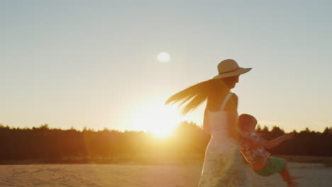 Young-Mother-With-Long-Hair-Playing-With-His-Son-At-Sunset-Fun-Turns-It-Around