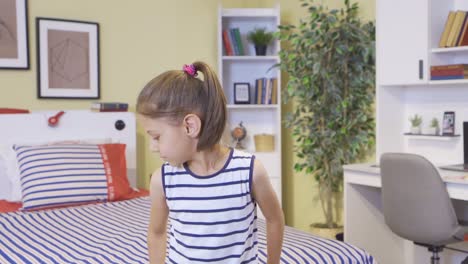 the girl lays herself on the bed by jumping.