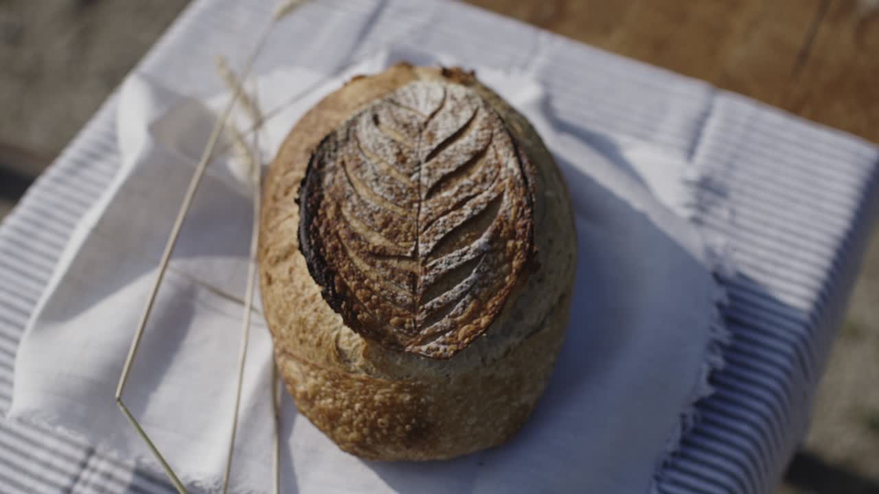 Lovely curved sourdough bread on a wooden table