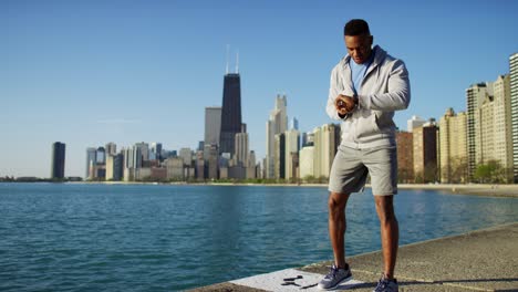 ethnic african american male running and stretching outdoors