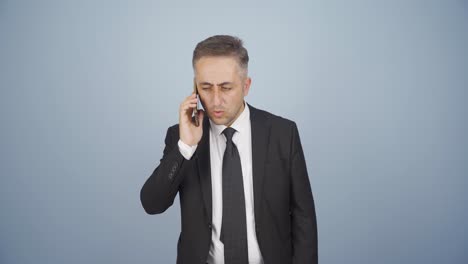 Businessman-getting-interrupted-and-angry-while-talking-on-the-phone.