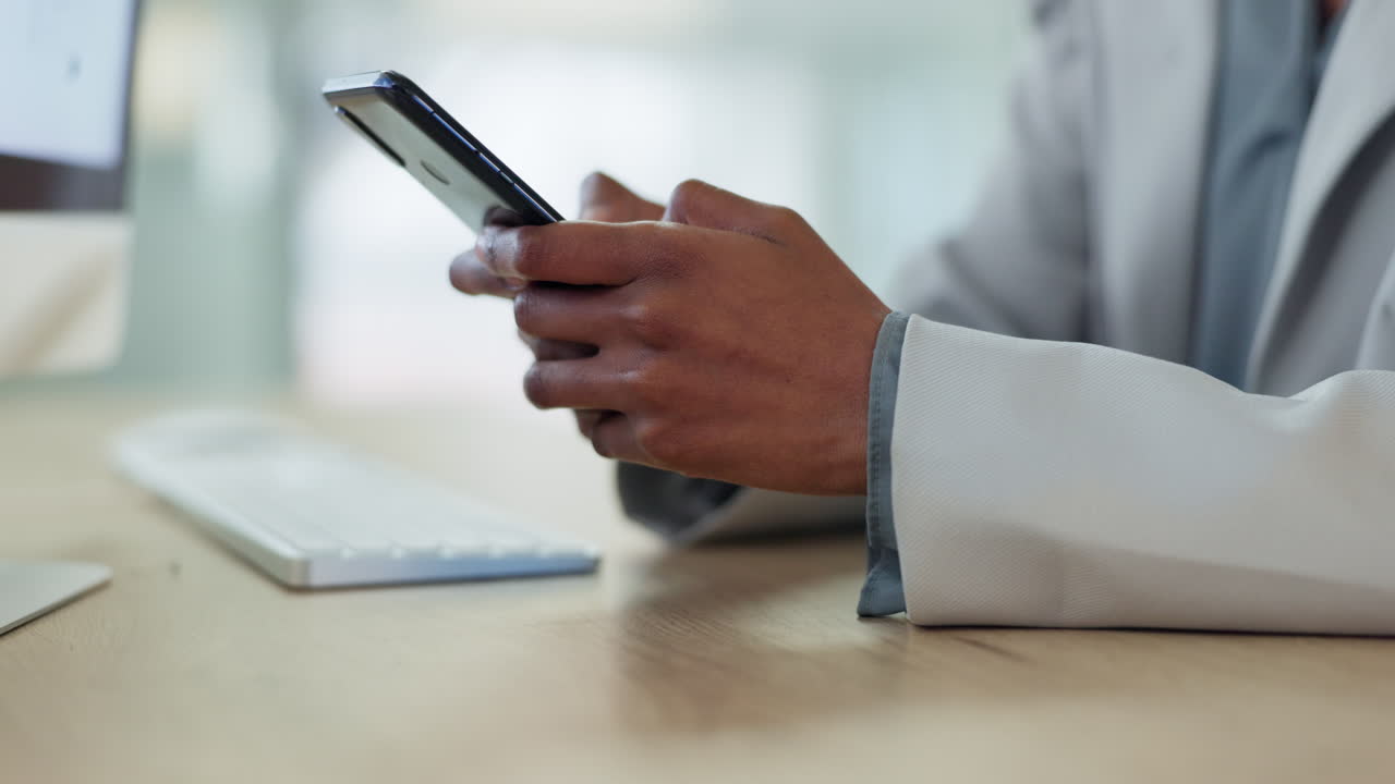 Hands, phone and typing closeup at desk in office
