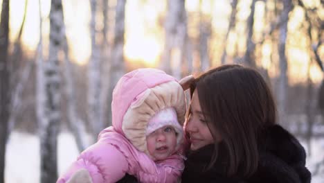 mother and baby in winter park