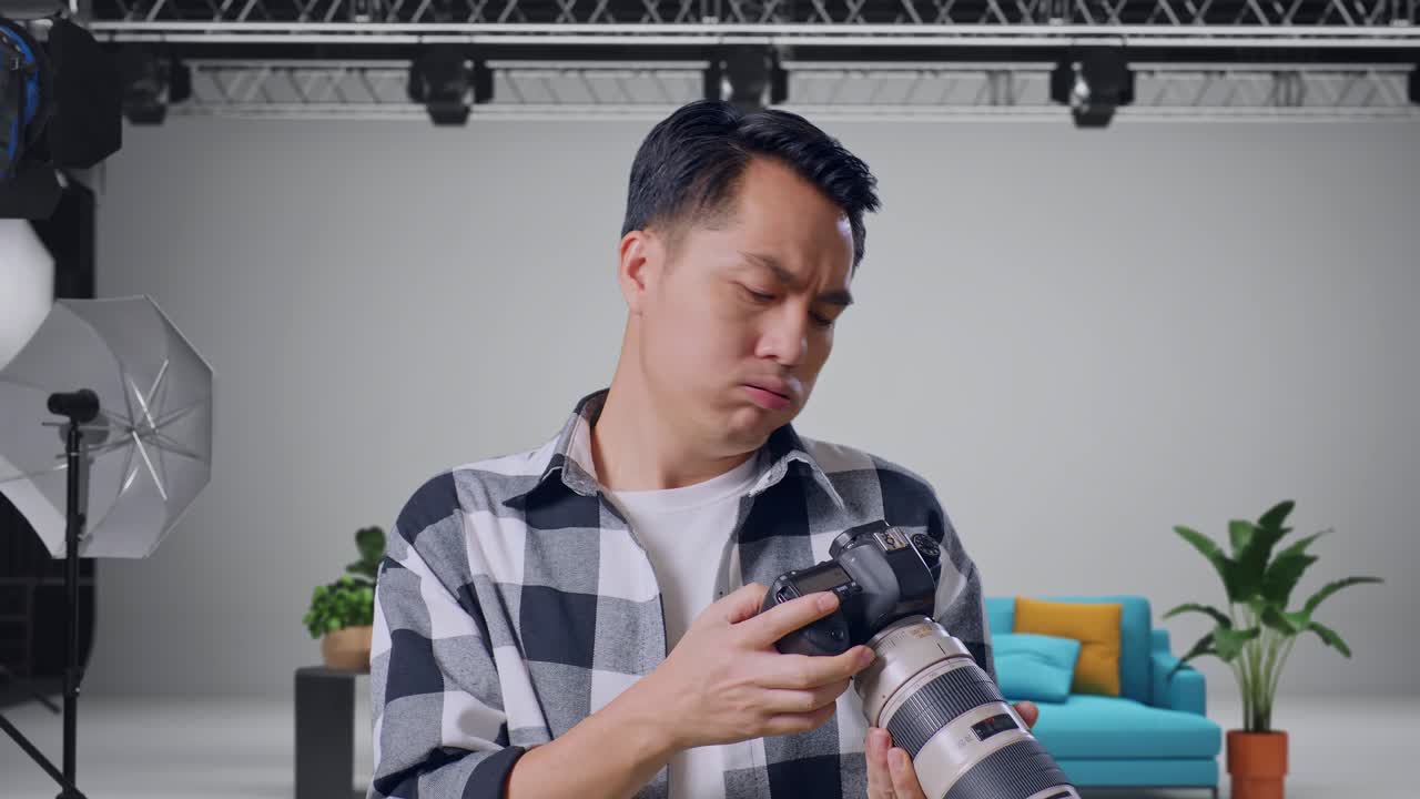 Photographer reviewing camera in a studio