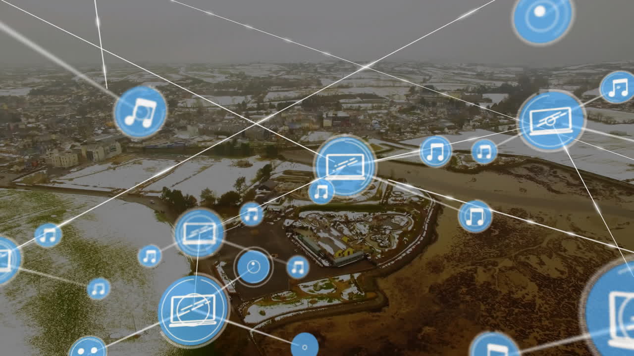 Music and media icons connected by lines animation over aerial view of snowy town