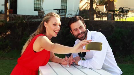 couple taking selfie with mobile phone while having wine 4k