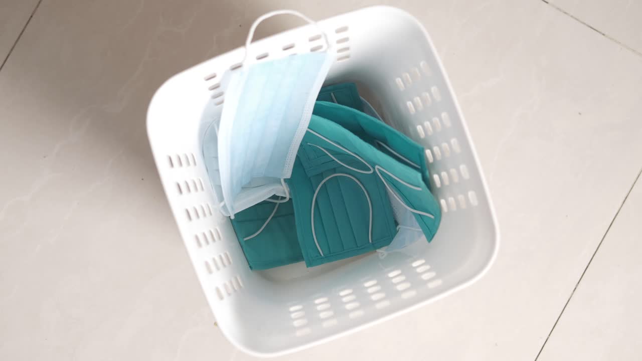 Discarded Face Masks in a White Basket