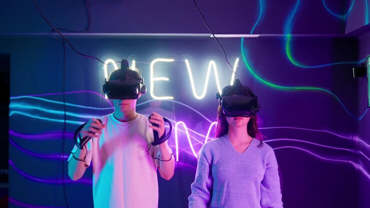 Young Couple Wearing VR Headsets and Holding Controllers in Neon Room