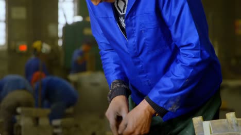 male worker making metal casting mold in foundry workshop 4k