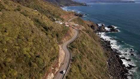 aerial push in shot of highway in a cliff on the coastline in chile