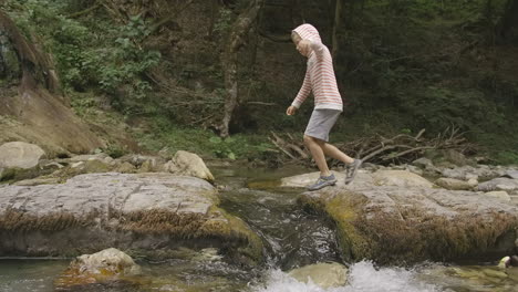 child exploring a mountain creek