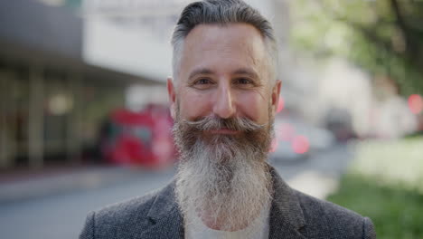 portrait-of-confident-businessman-with-beard-smiling-happy-enjoying-successful-urban-lifestyle-mature-male-entrepreneur-wearing-stylish-fashion-in-city-street-background-slow-motion