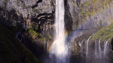 Beautiful-view-of-incredible-waterfalls-with-rainbow-against-massive-rocks