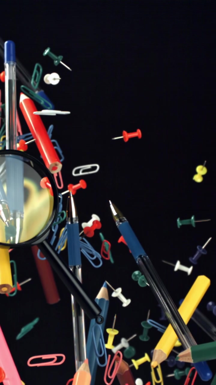 Colorful Office and School Supplies Floating on Black Background