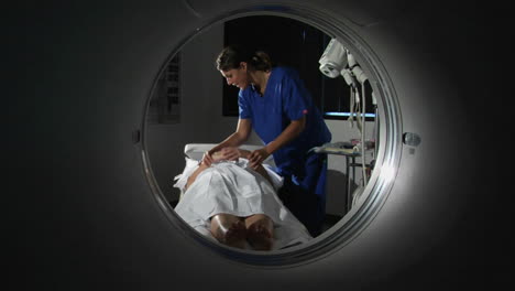 a doctor prepares a patient for a cat scan 2