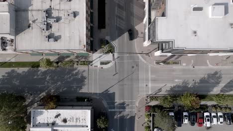 Holland,-Michigan-downtown-with-drone-video-overhead-and-moving-down-at-an-intersection-with-traffic-moving