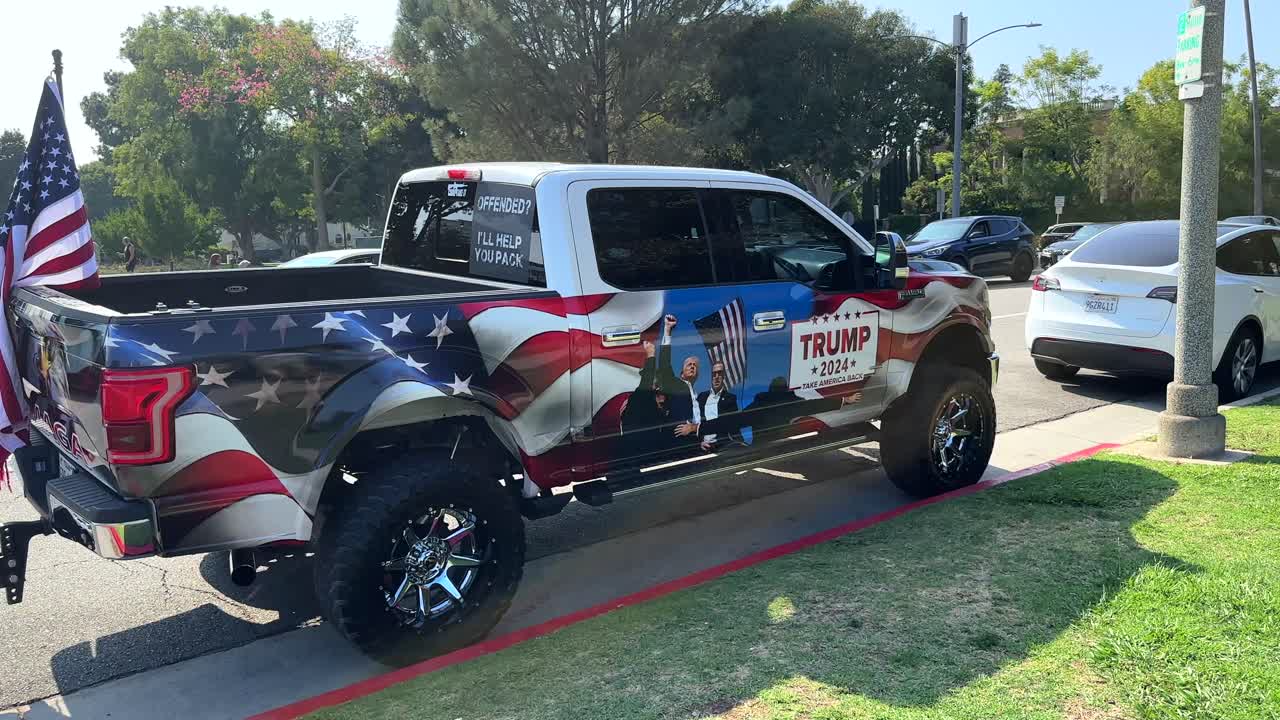 Bold images of pickup truck wrapped with 2024 Trump slogans and graphics and USA flag