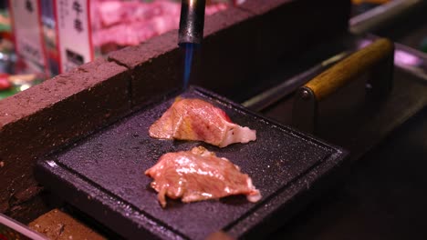 steak being cooked on a hot, black grill