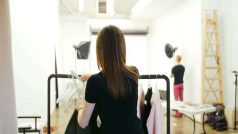 Female-model-trying-apparel-during-photo-shoot