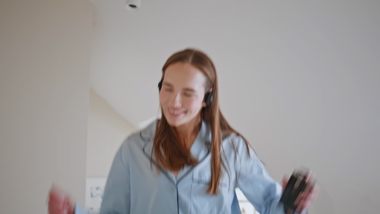 Fun girl dance bed in morning closeup. Excited carefree woman listening music