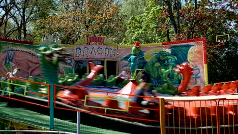 extreme and emotional entertainment for swinging dracon. carousel roundabout. swinging turning around attractions in the park and entertainment for adults and children. kaliningrad - may 2018 russian