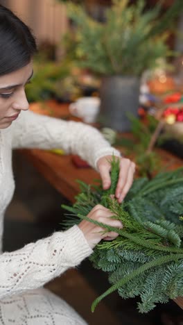 woman making a christmas wreath