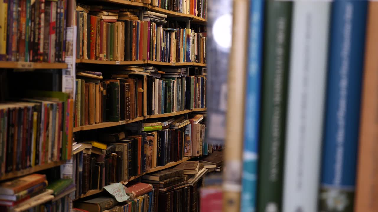 Shelves full of books, bookshelves in a library, bookstore or home office