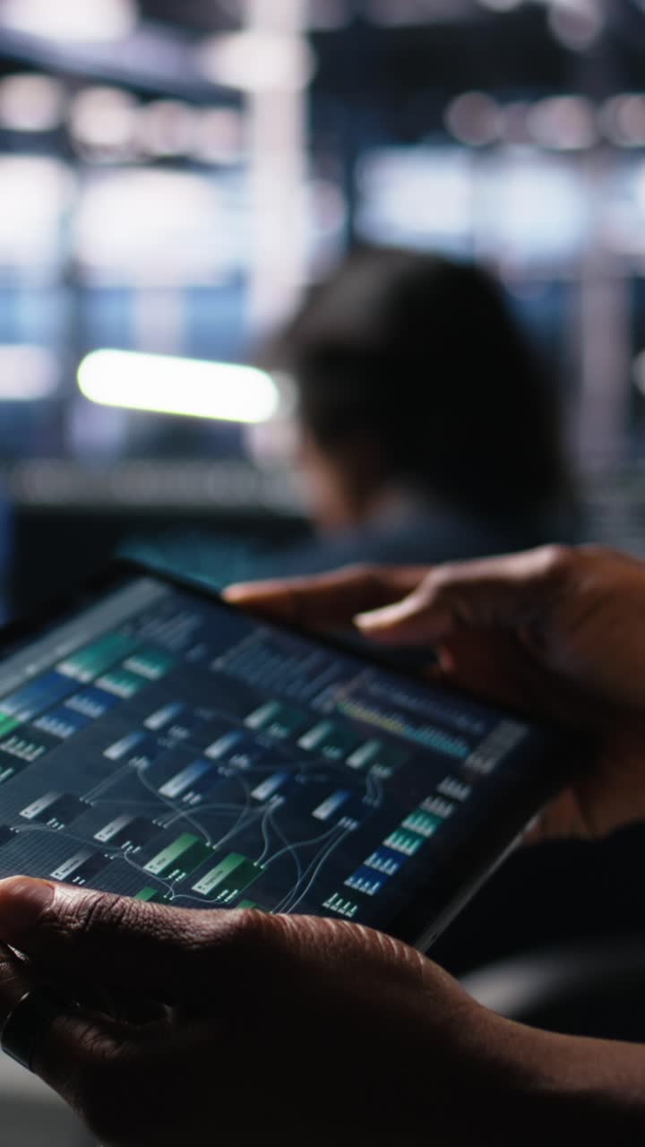 Vertical video Close up of data center programmer using tablet, writing code