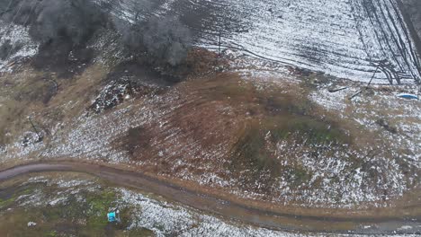 Birds-eye-view-over-ski-resort-with-very-little-snow-in-mid-winter