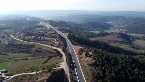 Aerial-view-of-cars-driving-on-a-road-in-the-countryside-of-Spain