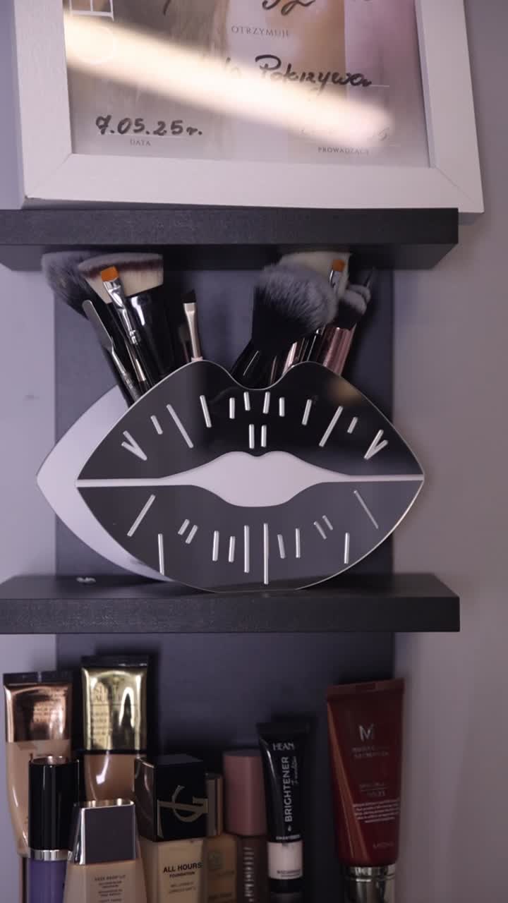 Makeup brushes and cosmetics on shelves