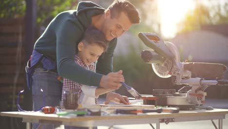 the father and son paint carpentry. slow motion