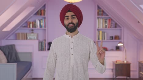 Sikh-Indian-man-showing-victory-sign