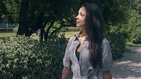 wonderful-girl-in-summer-dress-with-stripes-walks-in-park