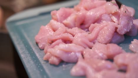 cooking chicken meat, roasting chicken meat in a pan in the kitchen by an italian cook.location: italy