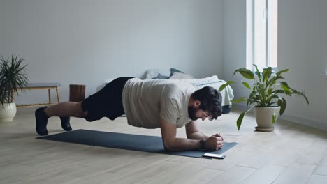 man doing a plank exercise at home