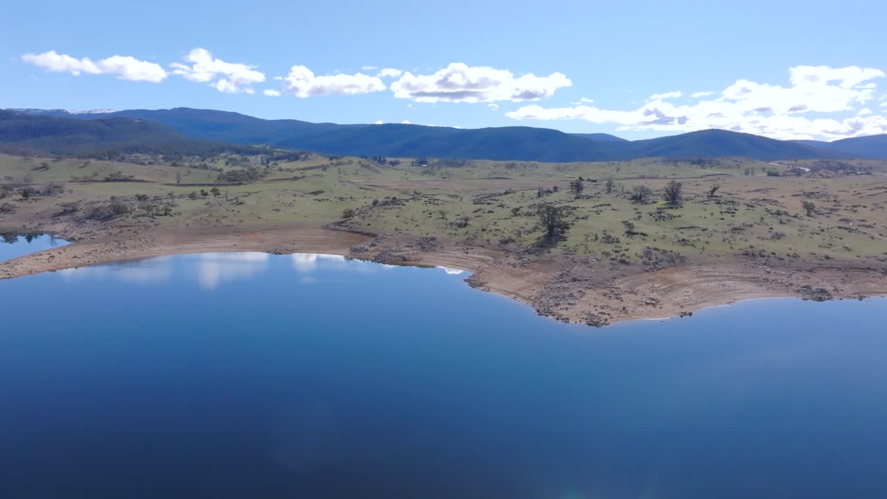 Aerial: Drone tracking along the shoreline of Lake Jindabyne, NSW, Australia